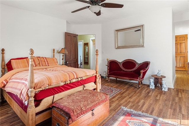 bedroom featuring dark wood-type flooring, ceiling fan, and baseboards