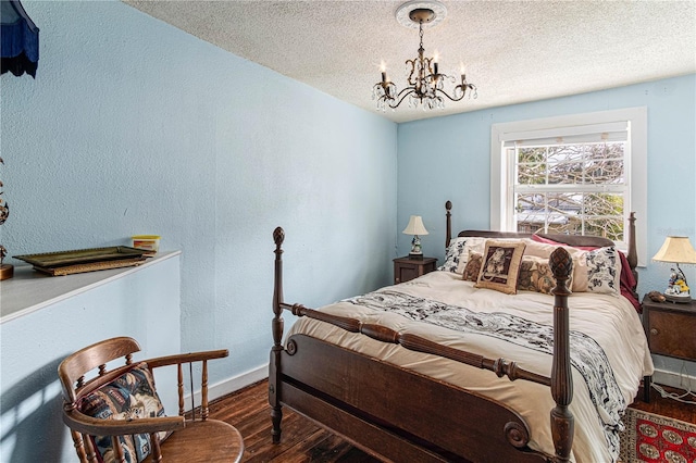 bedroom featuring baseboards, a textured ceiling, a chandelier, and dark wood-type flooring