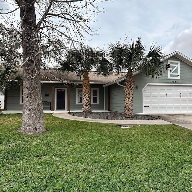 view of front of home featuring an attached garage, driveway, and a front lawn