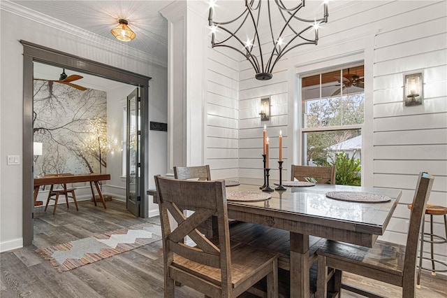 dining area featuring a ceiling fan, crown molding, baseboards, and wood finished floors