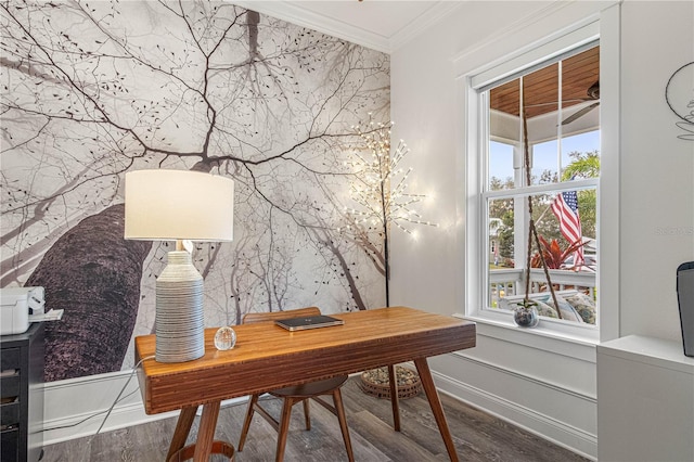 office space with an accent wall, ornamental molding, wood finished floors, and baseboards