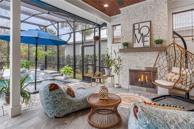 sunroom / solarium featuring a warm lit fireplace and wood ceiling