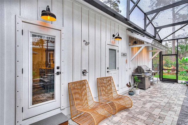 exterior space with board and batten siding and a patio area