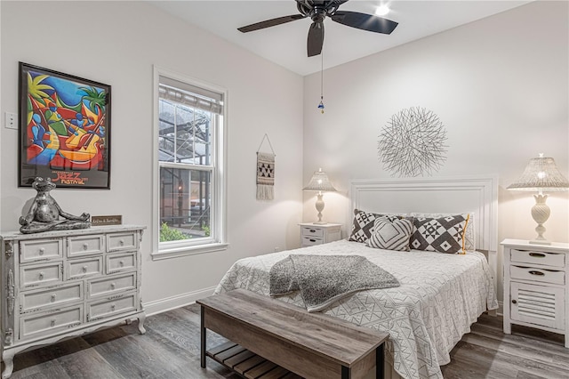 bedroom with baseboards, dark wood finished floors, and a ceiling fan