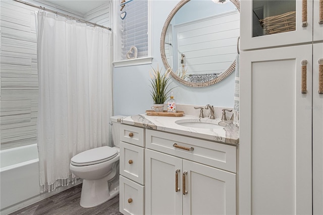 bathroom featuring vanity, shower / bath combination with curtain, wood finished floors, and toilet