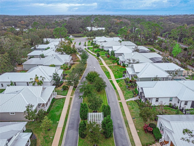 birds eye view of property with a forest view and a residential view