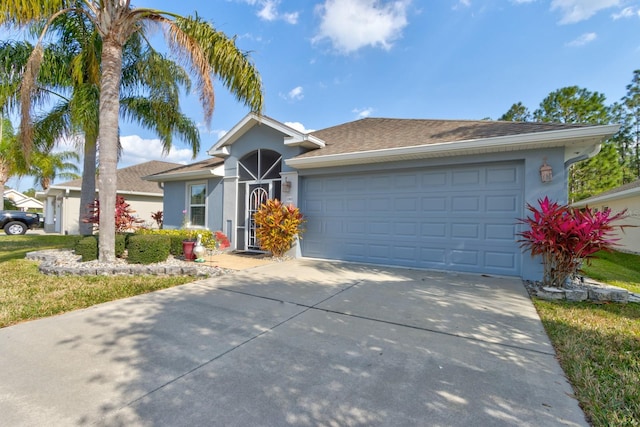 ranch-style house with a garage, concrete driveway, and stucco siding