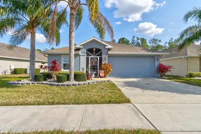 view of front of home with a garage, concrete driveway, a front yard, and stucco siding