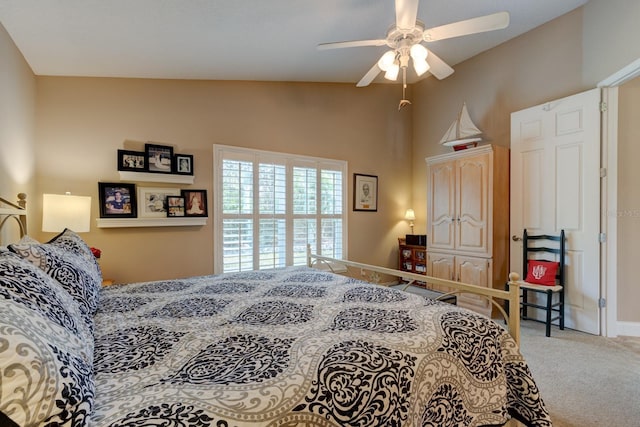 carpeted bedroom with lofted ceiling, ceiling fan, and baseboards