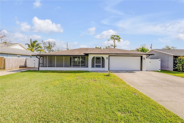 ranch-style house with concrete driveway, a sunroom, fence, a garage, and a front lawn