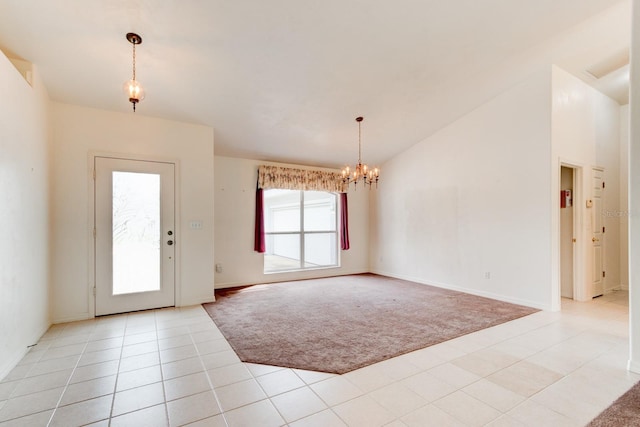 entryway with light tile patterned floors, lofted ceiling, light colored carpet, and an inviting chandelier