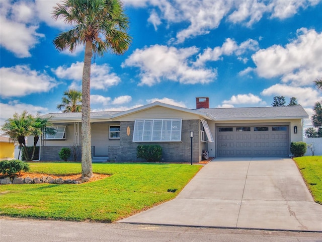 ranch-style home featuring a garage, a chimney, concrete driveway, and a front yard