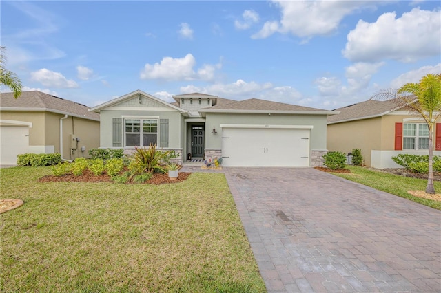 view of front facade with an attached garage, a front yard, decorative driveway, and stucco siding