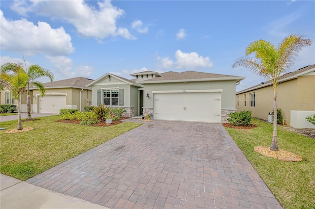 ranch-style house featuring stone siding, an attached garage, decorative driveway, a front lawn, and stucco siding