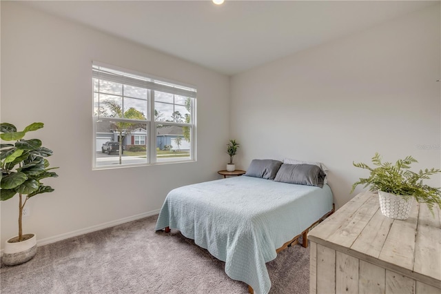 bedroom featuring carpet and baseboards