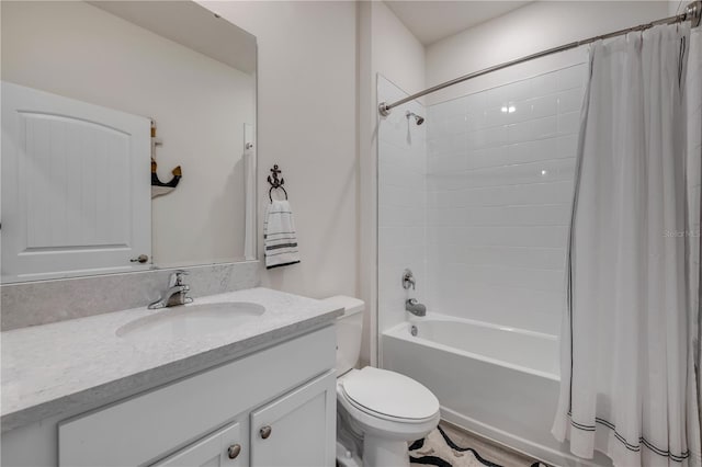 full bath with shower / bath combo, vanity, and toilet