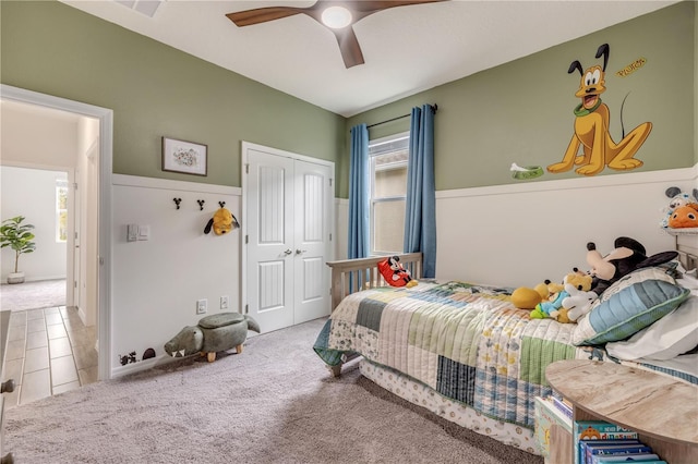 carpeted bedroom featuring a closet and a ceiling fan