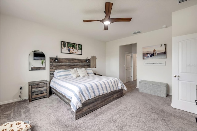 bedroom with visible vents, a ceiling fan, and light colored carpet