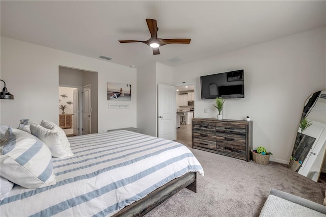 bedroom with baseboards, carpet floors, visible vents, and a ceiling fan