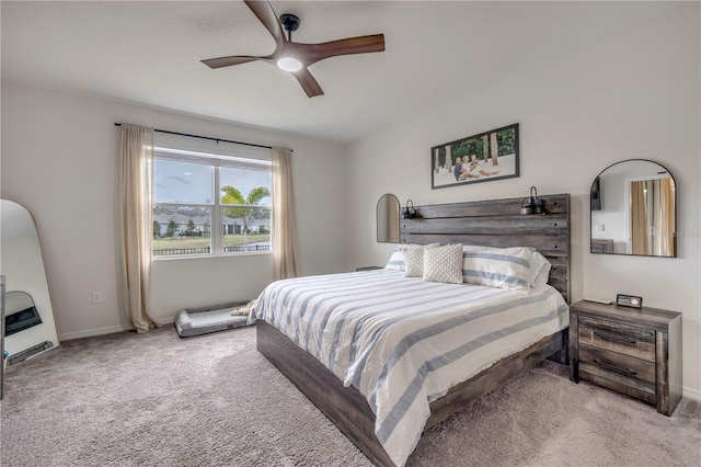 bedroom with a ceiling fan, light colored carpet, and baseboards