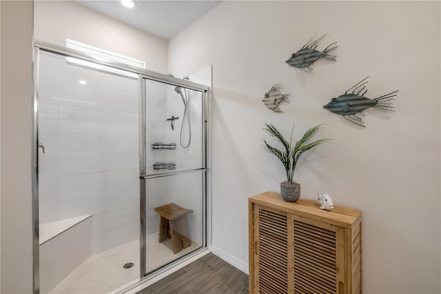 bathroom featuring a shower stall and wood finished floors