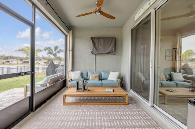 sunroom featuring a ceiling fan