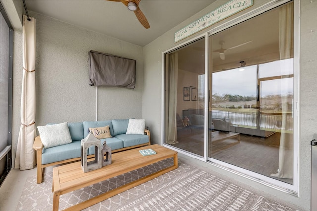 sunroom featuring ceiling fan