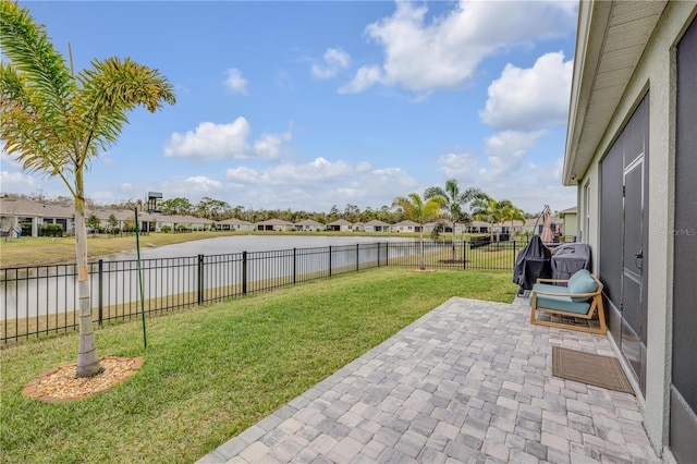 view of patio / terrace featuring a water view, a fenced backyard, and a residential view