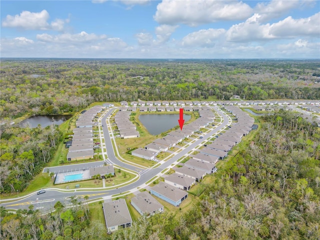 aerial view with a water view and a view of trees