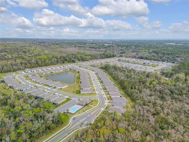 aerial view with a forest view and a water view