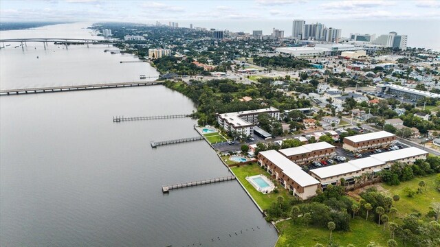 birds eye view of property with a view of city and a water view