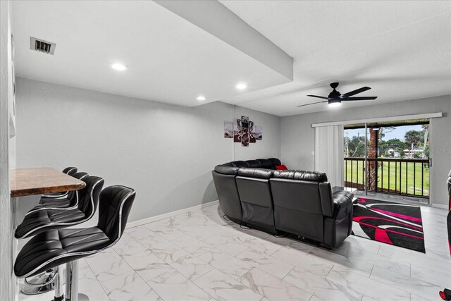 home theater room with baseboards, visible vents, ceiling fan, marble finish floor, and recessed lighting