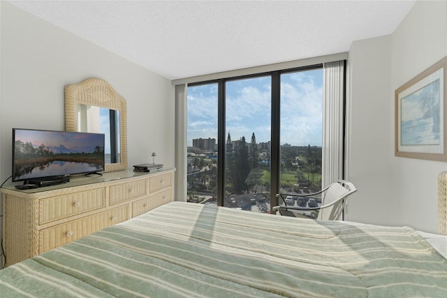 bedroom featuring a textured ceiling and a city view