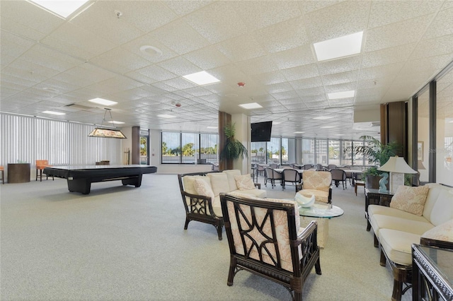 interior space with light carpet, a drop ceiling, and a wealth of natural light