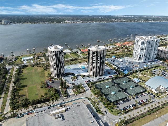 birds eye view of property with a water view and a city view