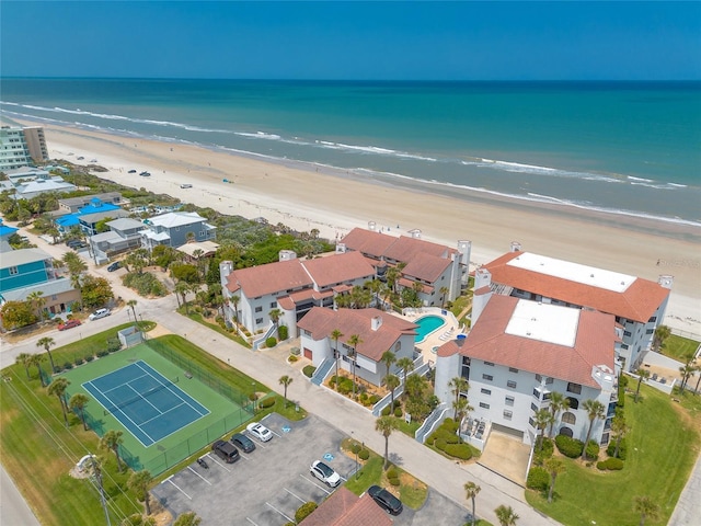 drone / aerial view with a water view and a beach view