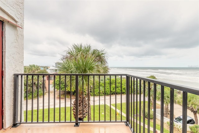 balcony with a water view and a beach view