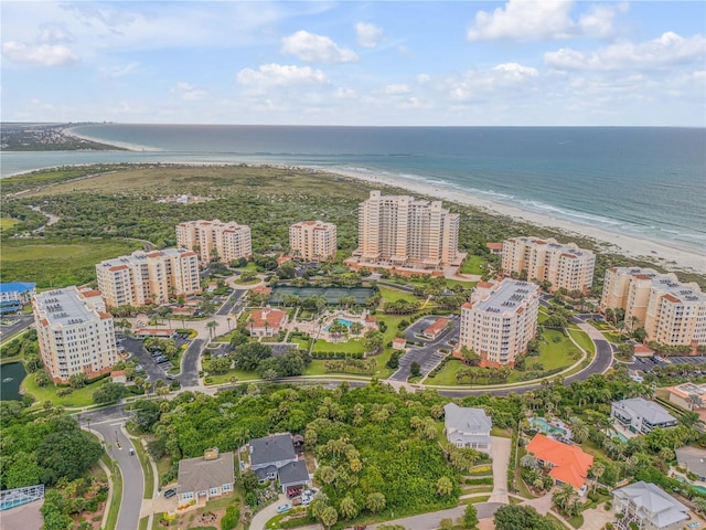 drone / aerial view featuring a view of city, a water view, and a view of the beach