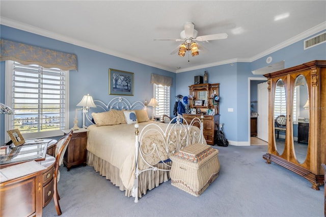 carpeted bedroom featuring baseboards, visible vents, ceiling fan, and ornamental molding