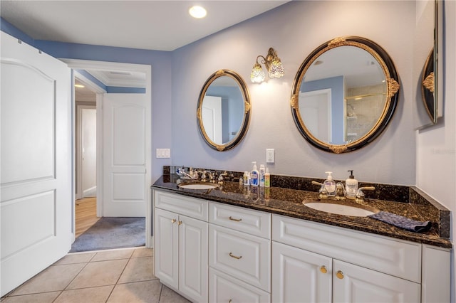 bathroom featuring double vanity, a sink, and tile patterned floors