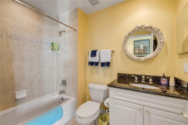 full bathroom featuring toilet, vanity, visible vents, and shower / bathtub combination