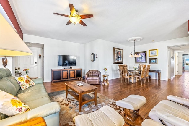 living room featuring wood finished floors and ceiling fan with notable chandelier