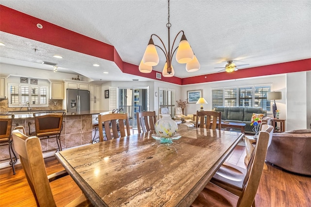 dining area with plenty of natural light, a textured ceiling, a ceiling fan, and wood finished floors