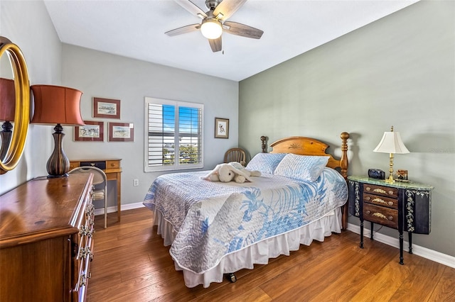 bedroom featuring ceiling fan, baseboards, and wood finished floors