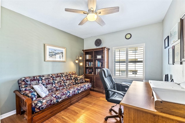 office featuring ceiling fan, light wood-style flooring, and baseboards