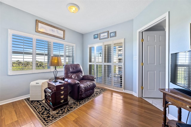 sitting room with wood finished floors and baseboards