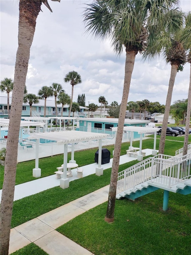 community pool with a lawn and fence