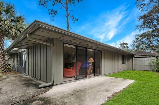 view of outbuilding featuring fence