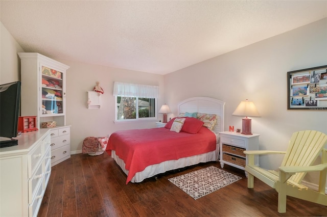 bedroom featuring a textured ceiling and hardwood / wood-style floors