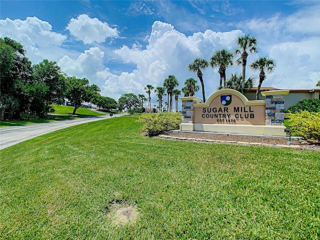 community sign featuring a yard